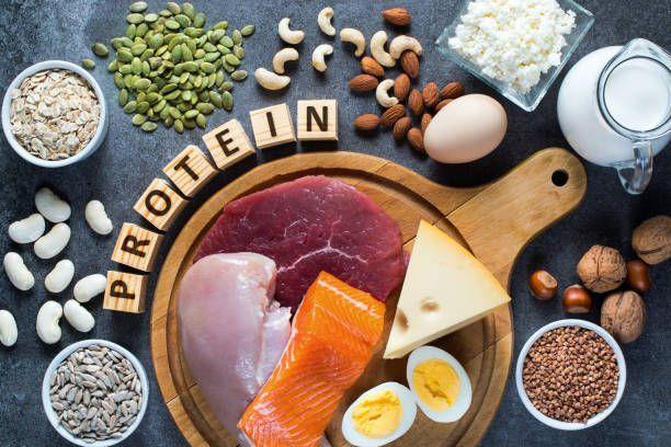 protein, eggs, nuts, and other foods on a wooden board