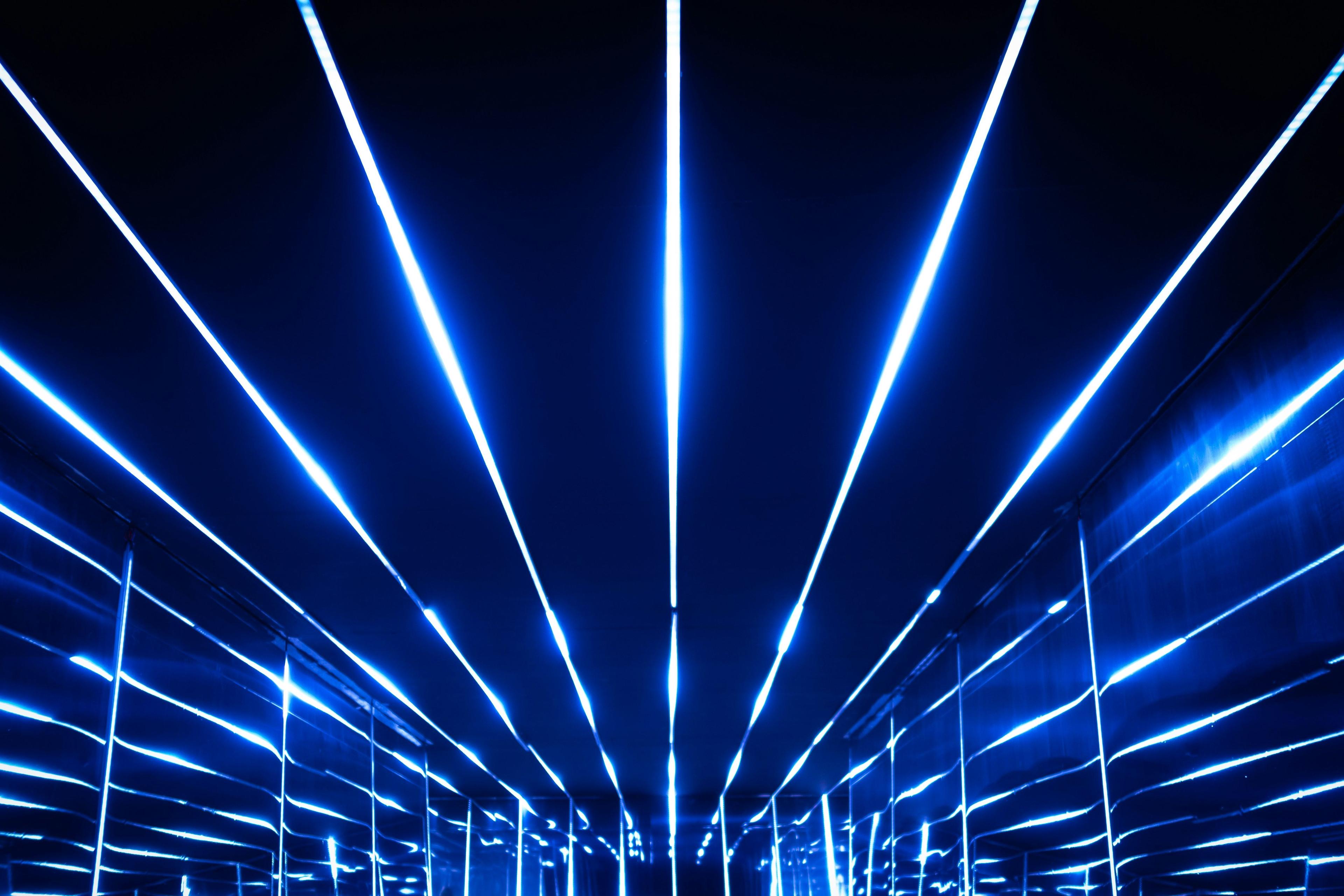 an image of a blue light in a dark hallway