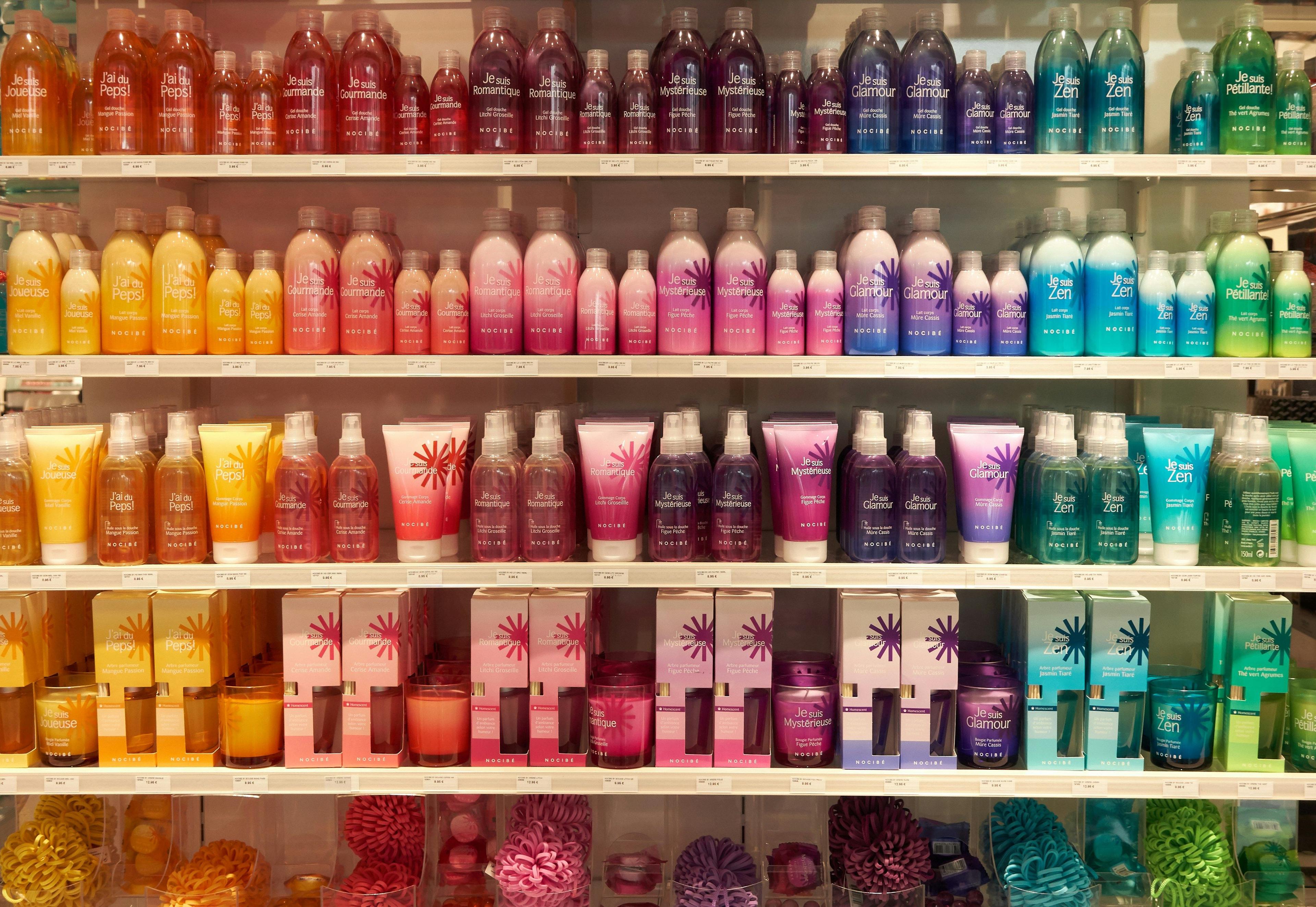 a shelf filled with lots of different colored bottles