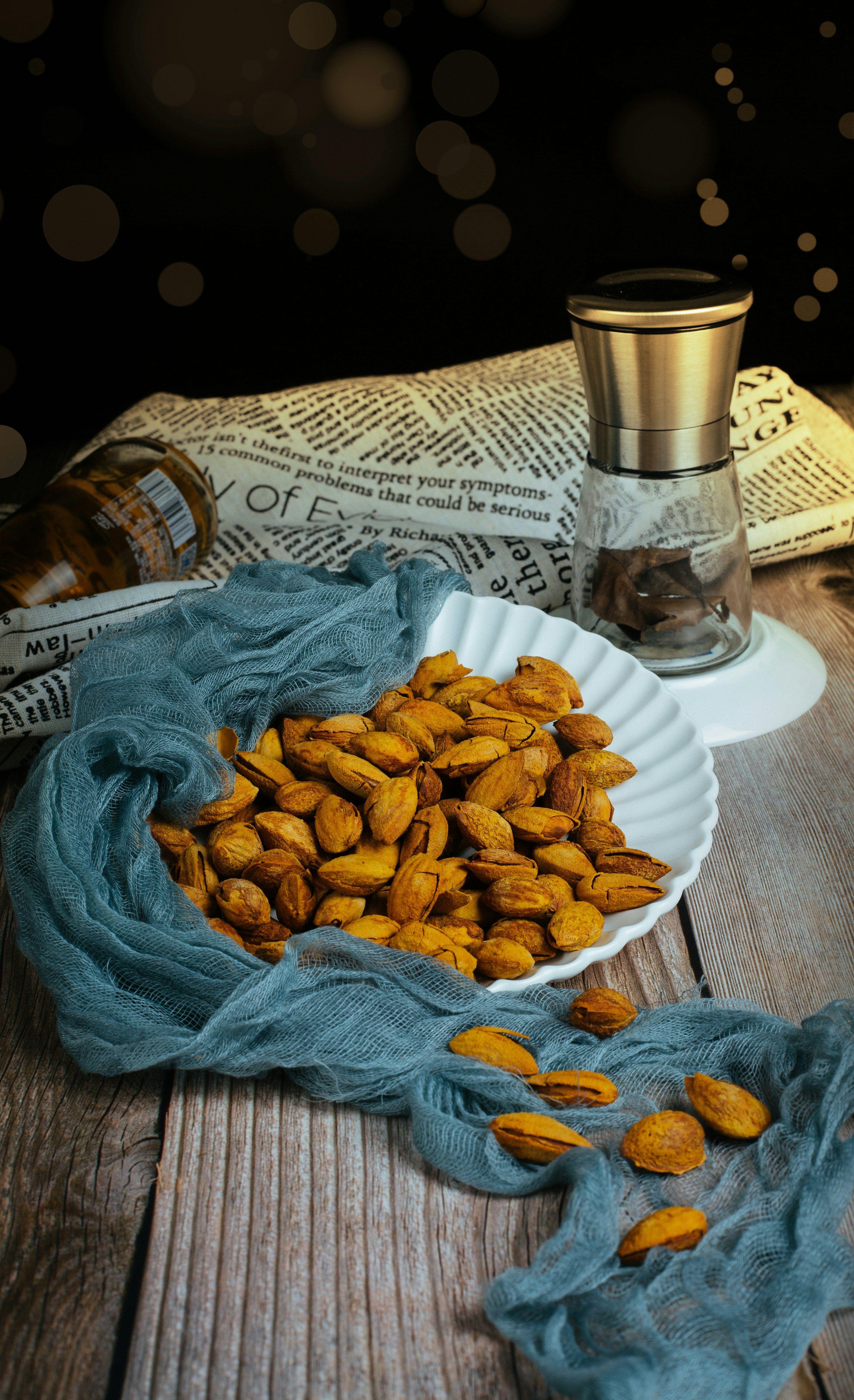 a plate of almonds on a wooden table