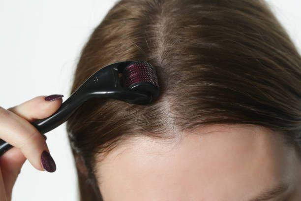 a woman is combing her hair with a brush