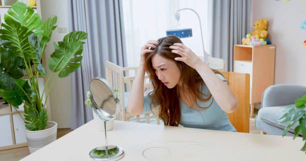 a woman is looking at her hair in front of a mirror