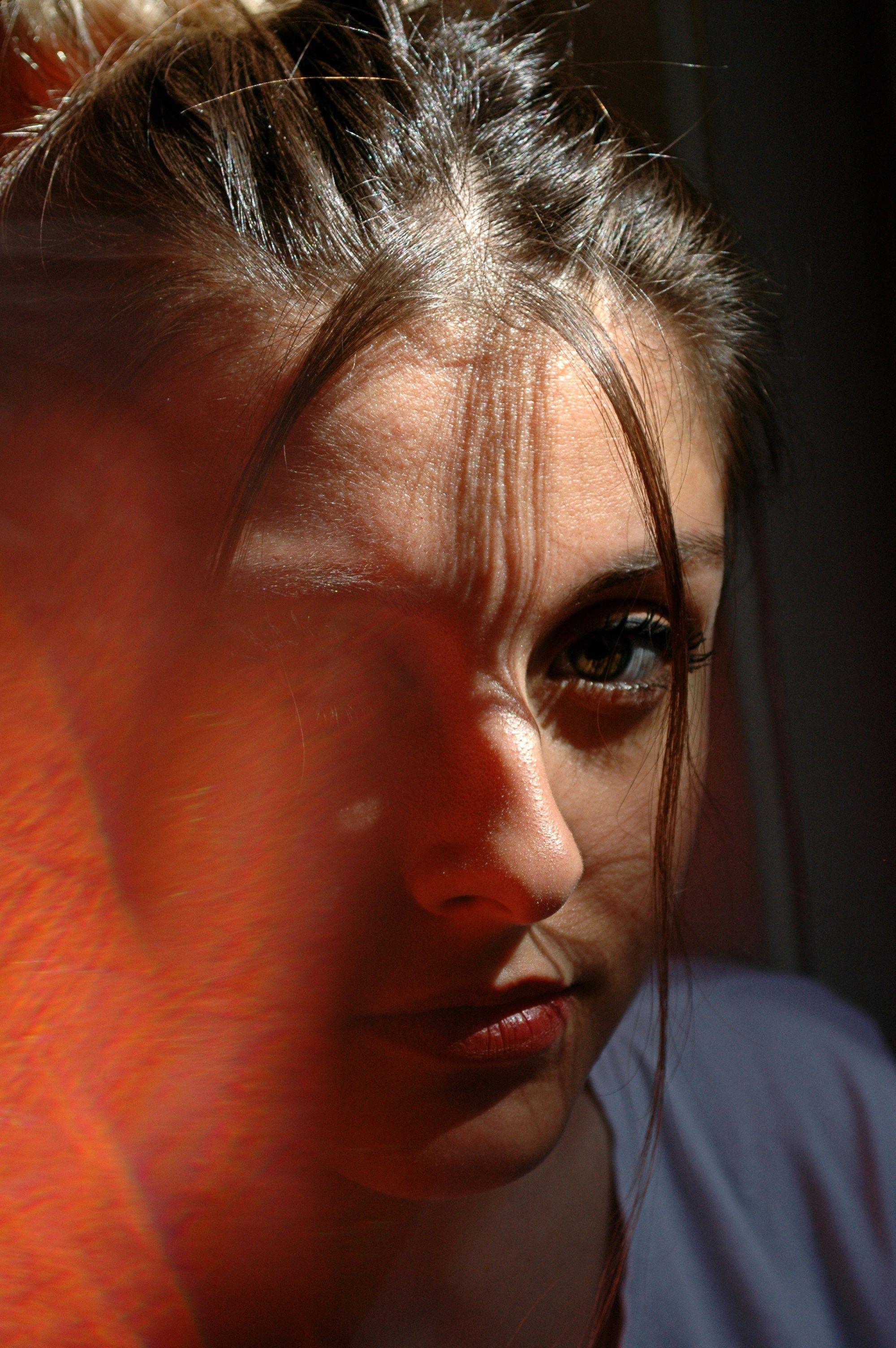 a close up of a woman's face with a blurry background