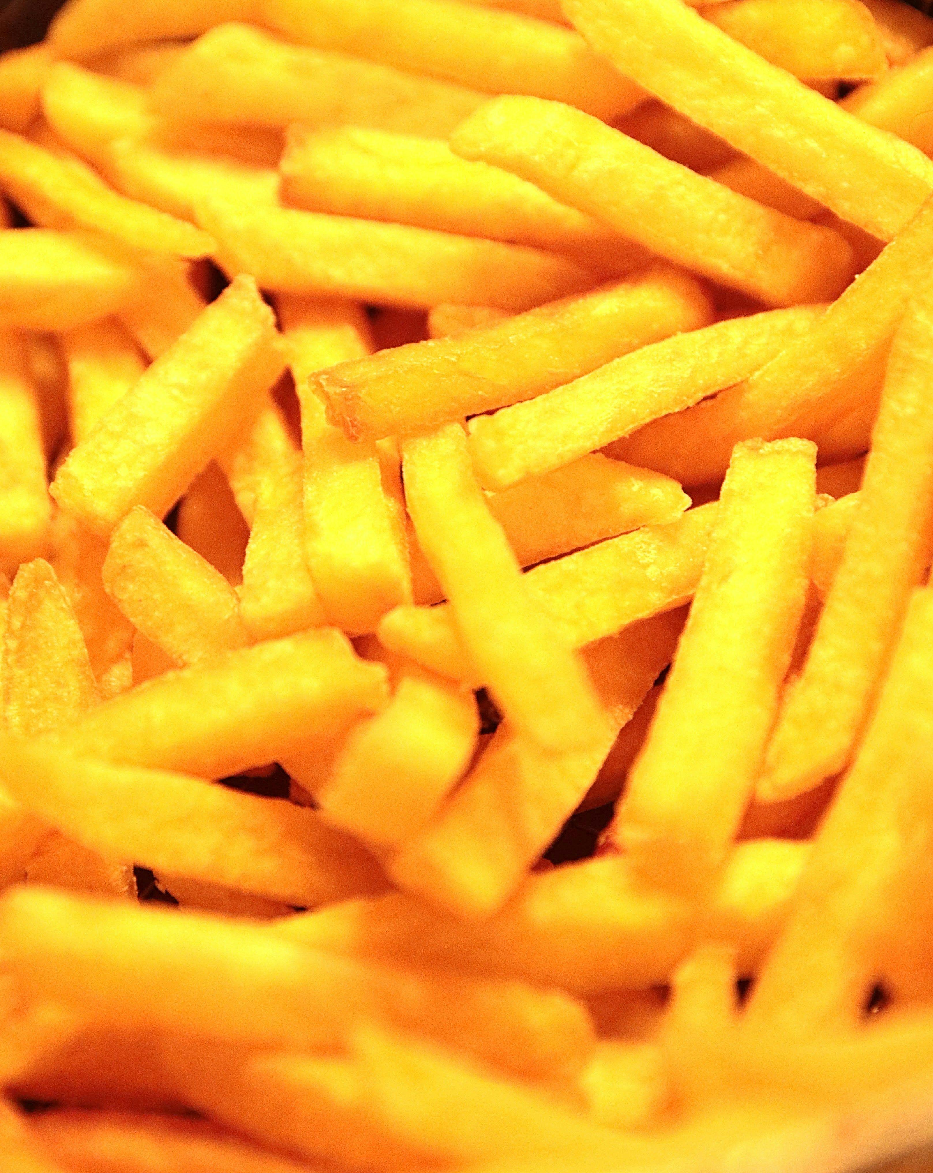 a pile of french fries sitting on top of a table